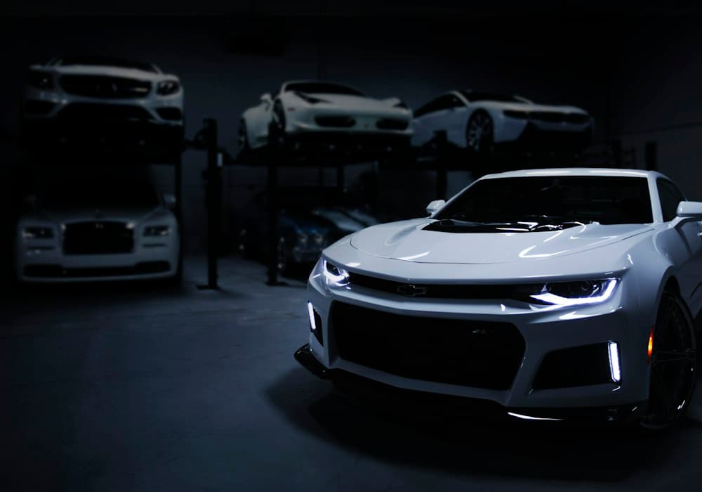 Garage with multiple cars annotated for detection.